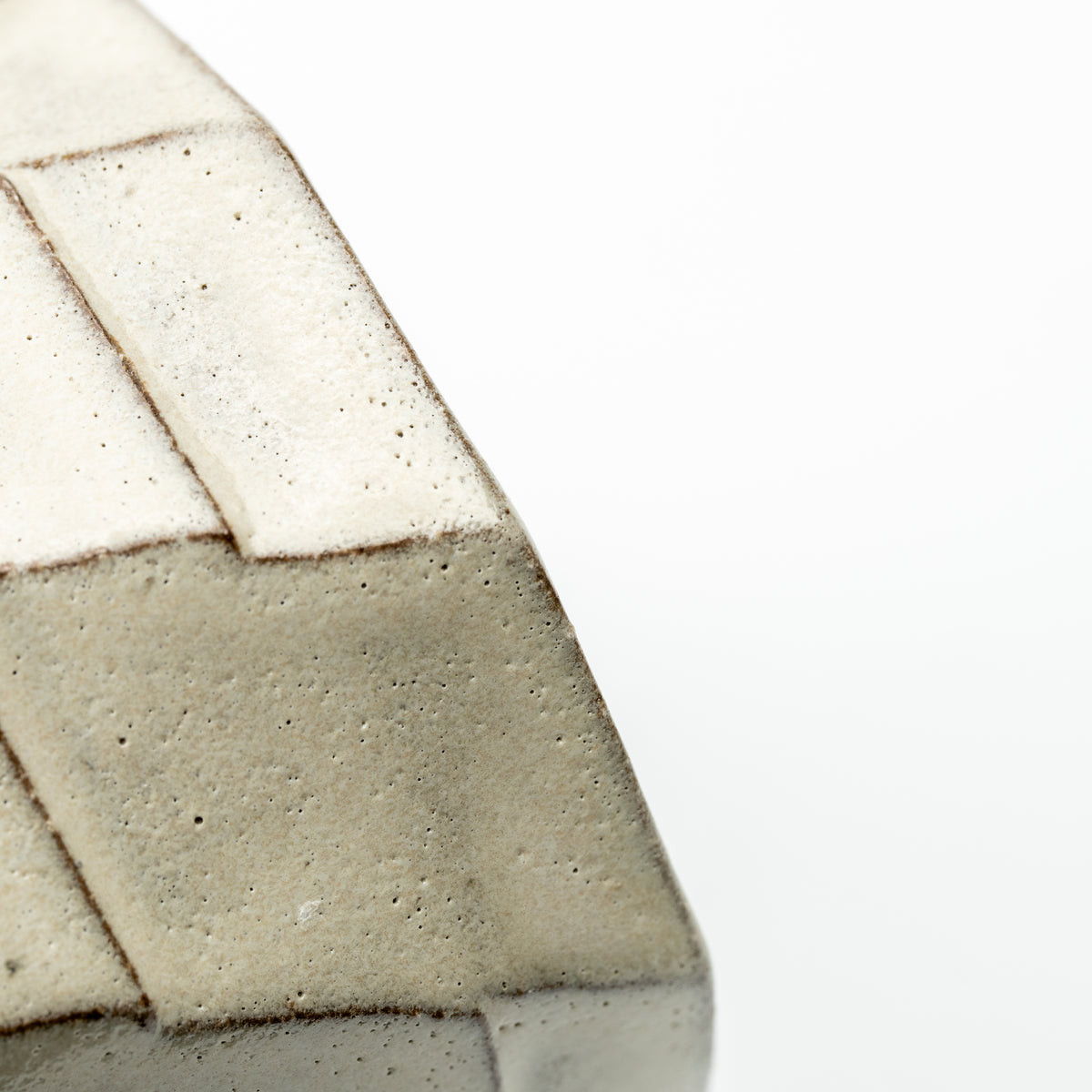 Close-up of the Greige mug's textured gray and cream panels with dark outlines.