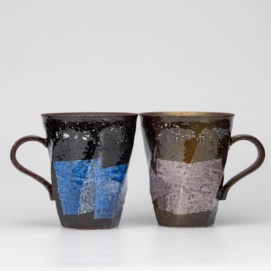 Blue and lilac ginsai mug pair, side view showing the shape and surface.