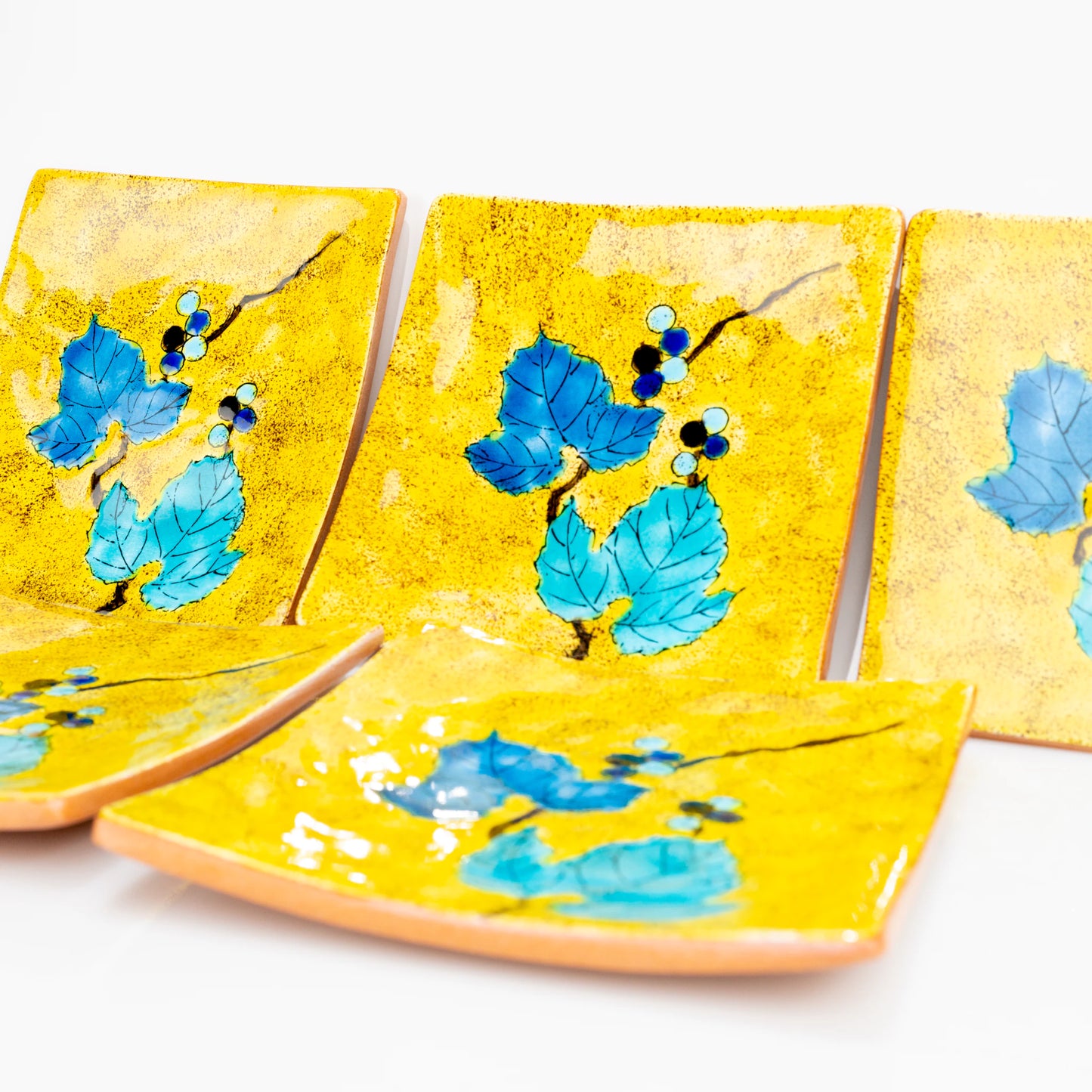 Close view of Kutani Yoshidaya wild grape square plates layered together