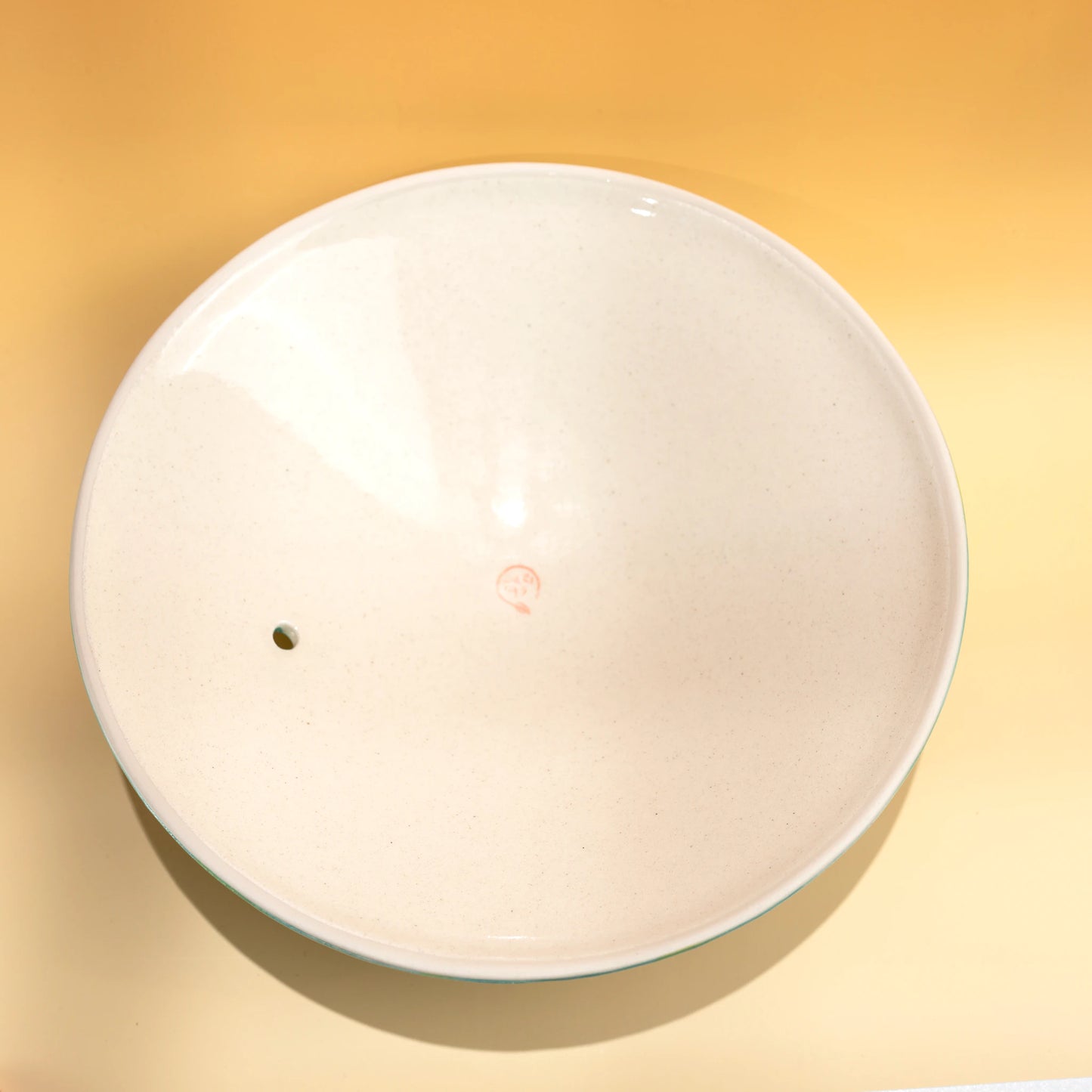 Interior view of the white porcelain lid for a Japanese donabe clay pot