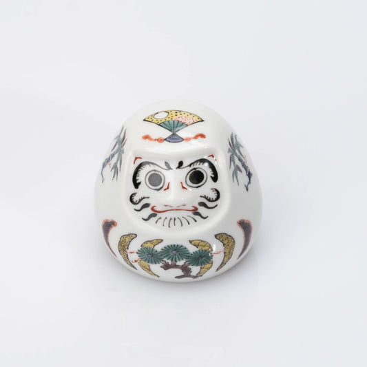Angled front view of Kutani Daruma with pine, bamboo and plum design