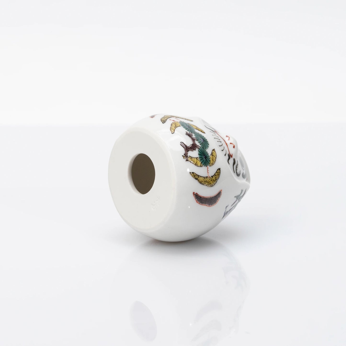 Underside and side detail of Kutani Daruma figurine