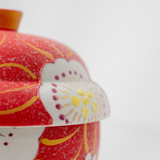 Close-up of the cherry blossom motif on a red Arita lidded bowl