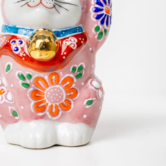 Front detail of floral kutani-style lucky cat figurine