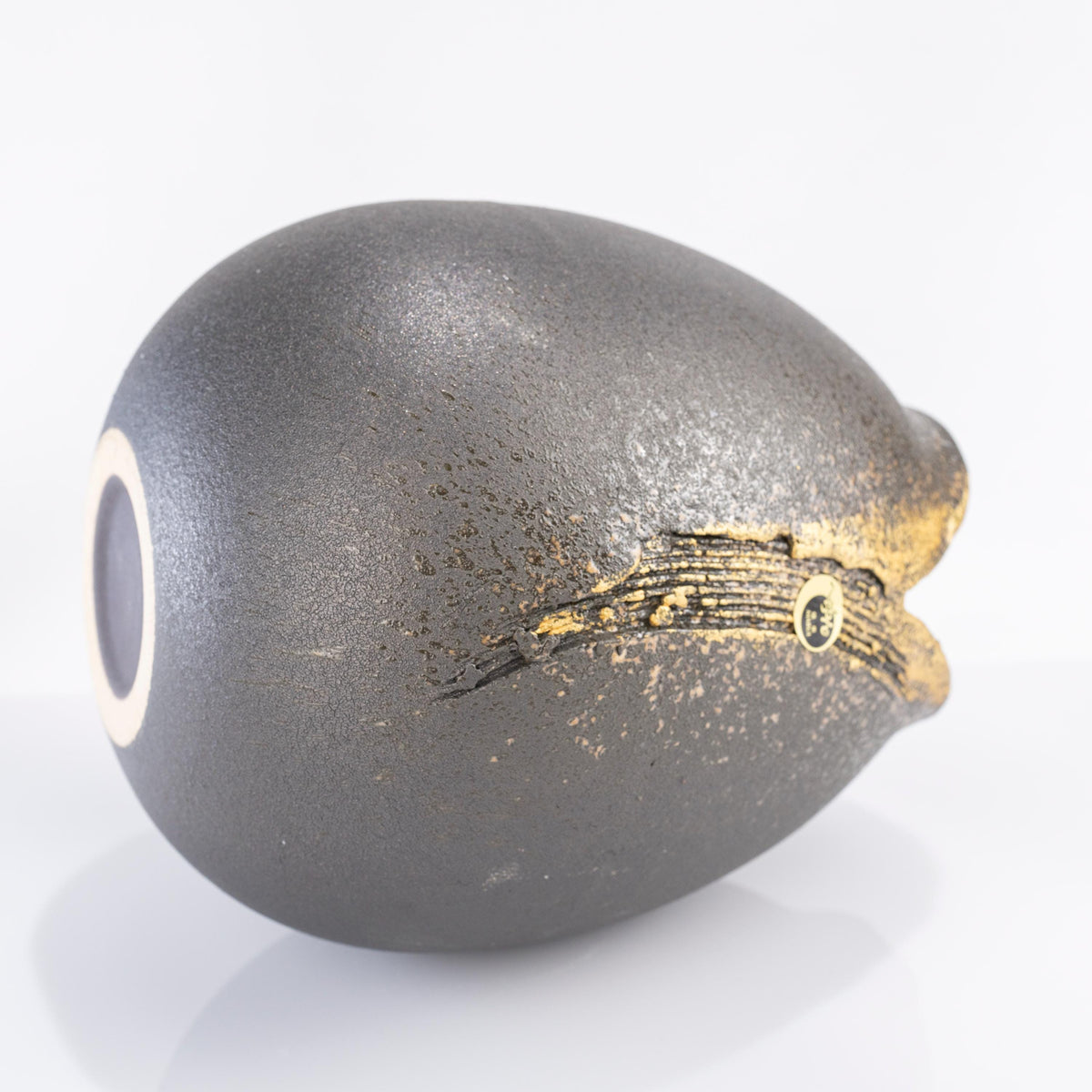 Banju teardrop vase laid on its side, showing its round base and gold brushwork beneath the V-shaped rim
