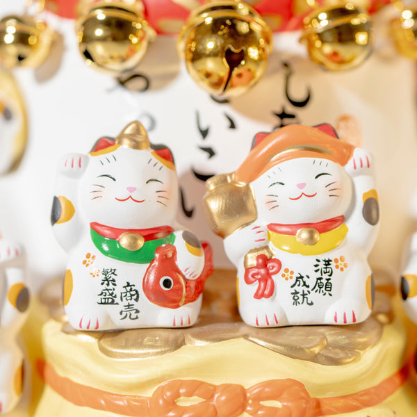Front detail of Seven Lucky Gods on a ceramic lucky cat statue