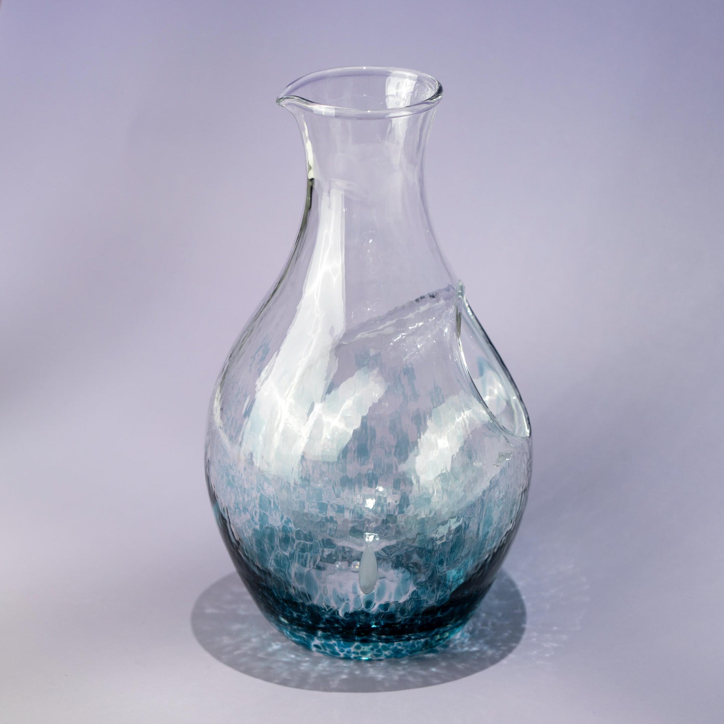 Top view of handmade blue sake carafe with flowing glass pattern