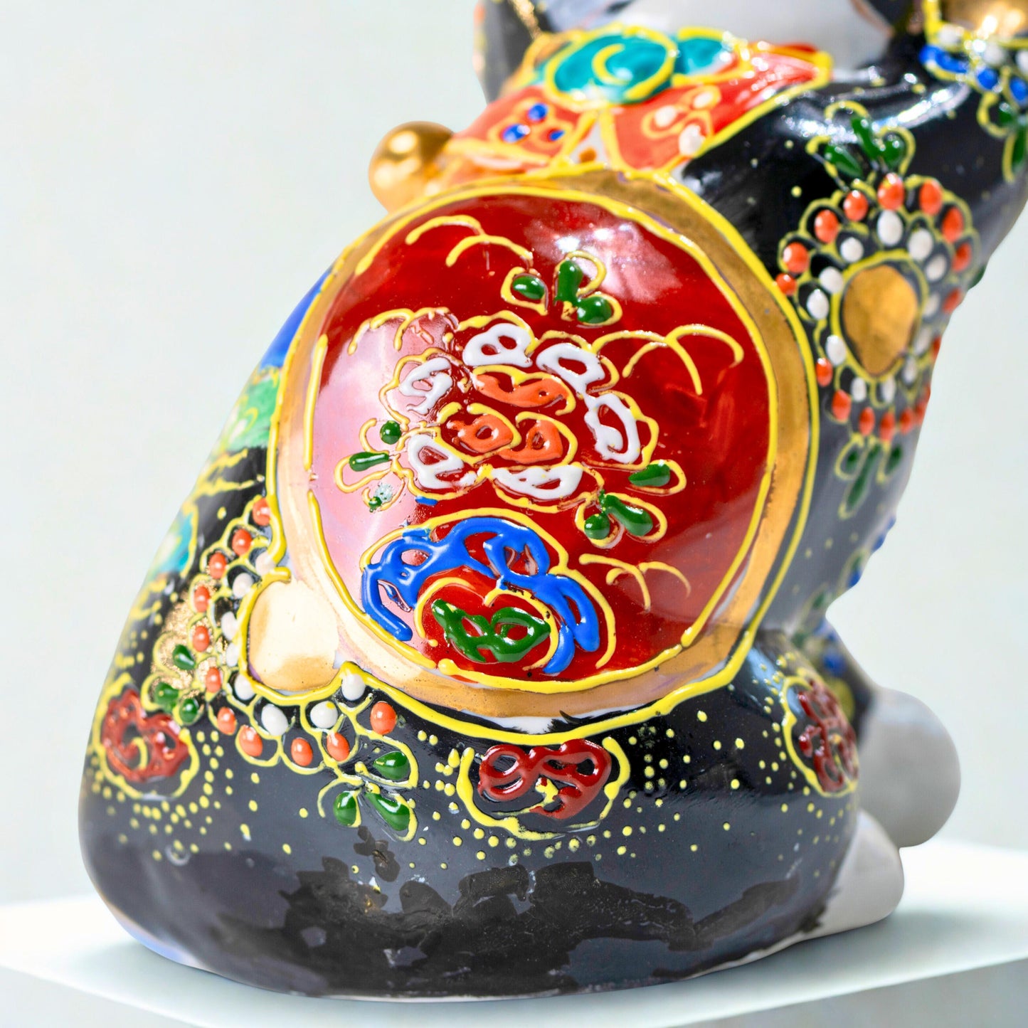 Close-up of painted Mount Fuji detail on Kutani lucky cat