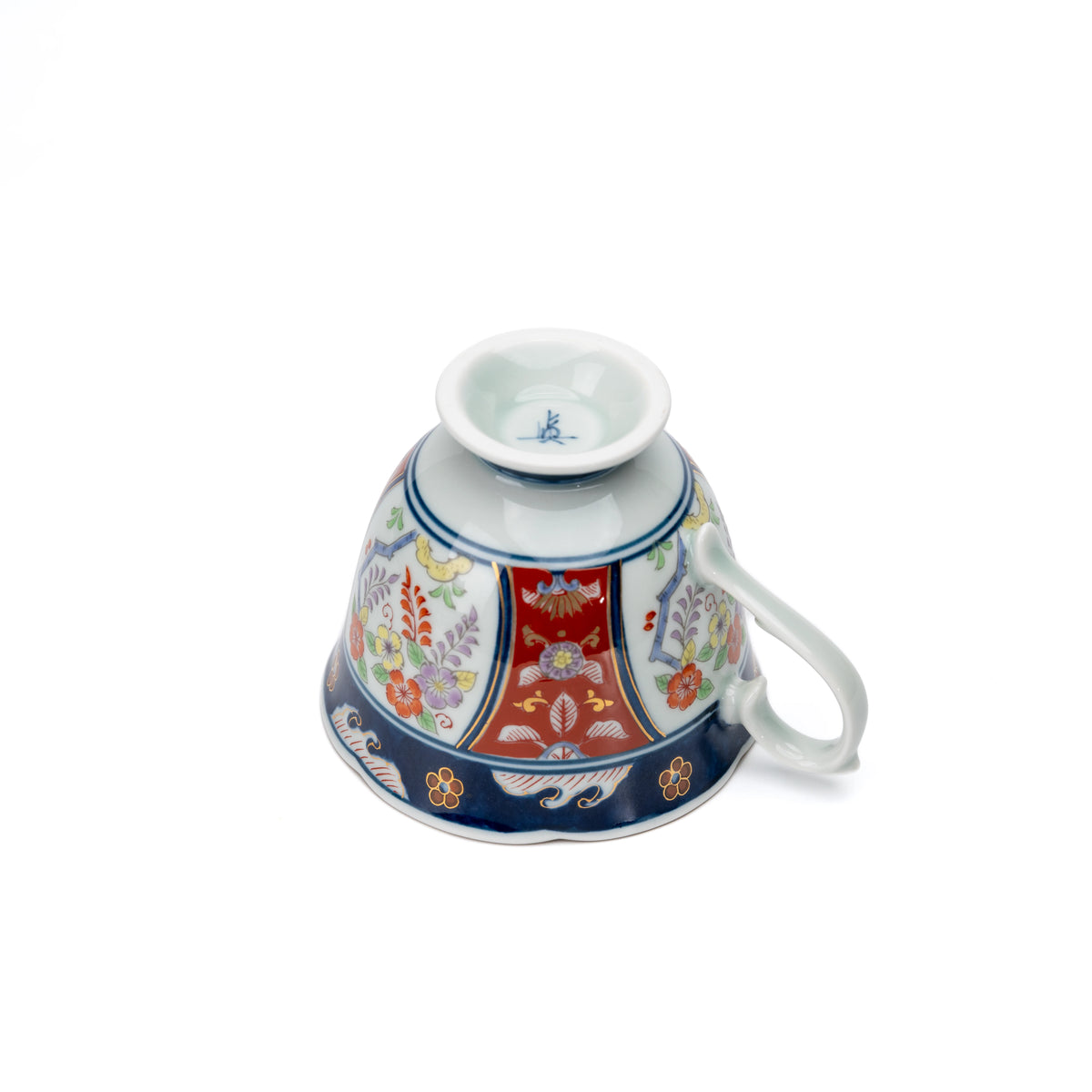 Underside of the floral cup with a small blue maker's mark.