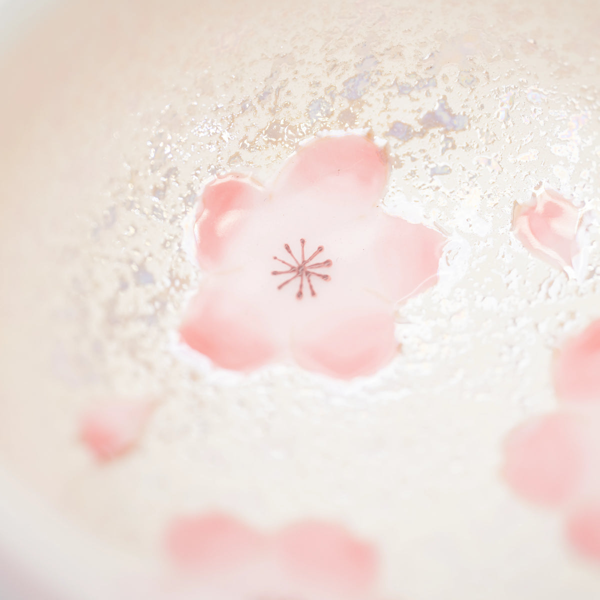 Pink flower painted inside the porcelain bowl.