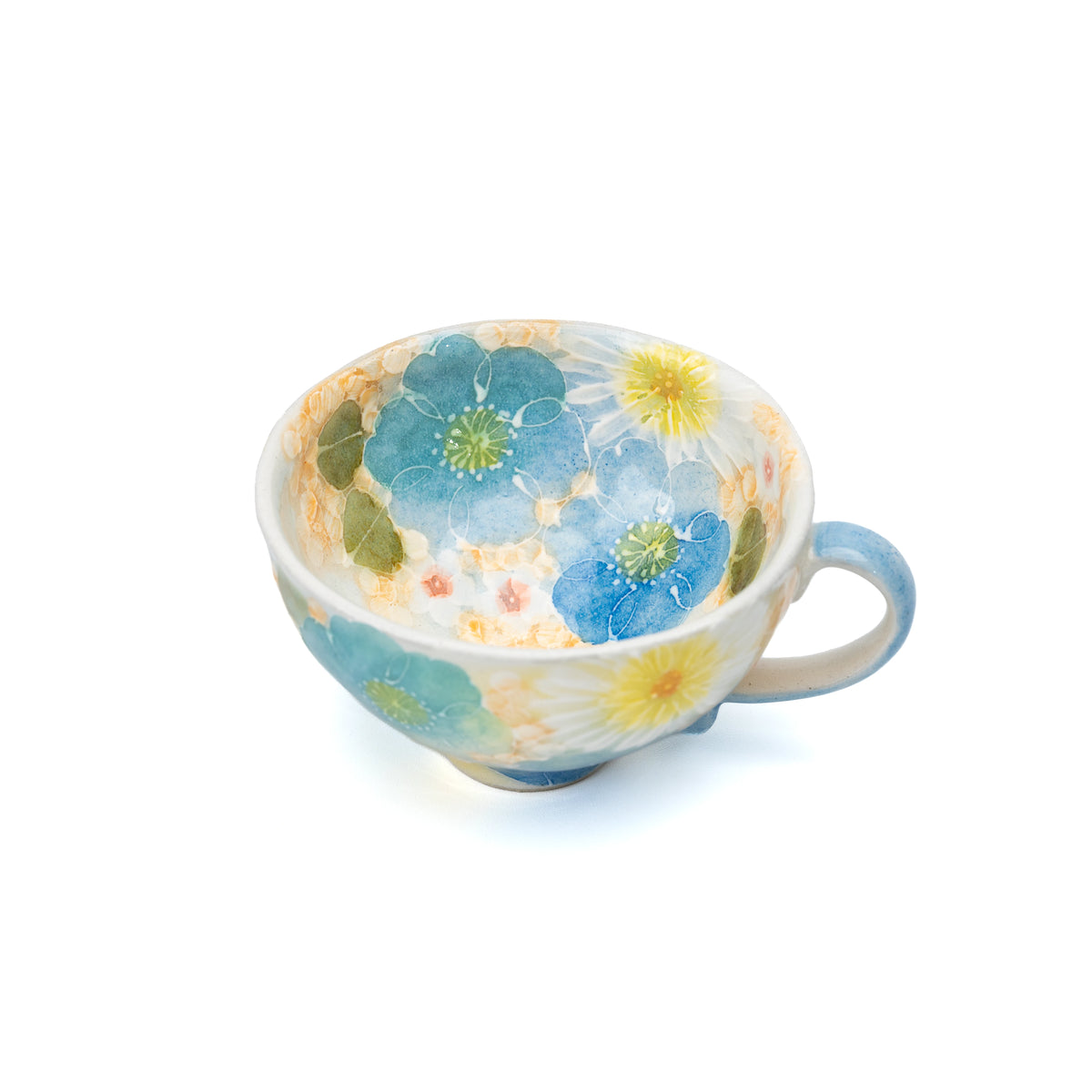 Top view into the blue floral cup and its cream interior.