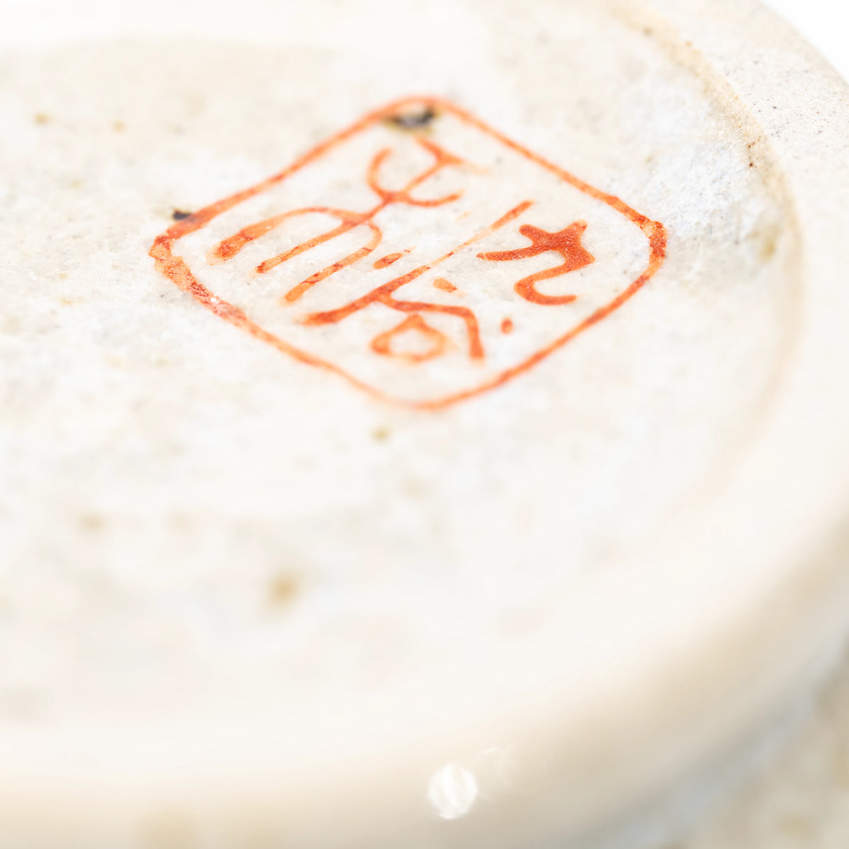 Close-up of the red maker's mark underneath the Kutani three owls mug.
