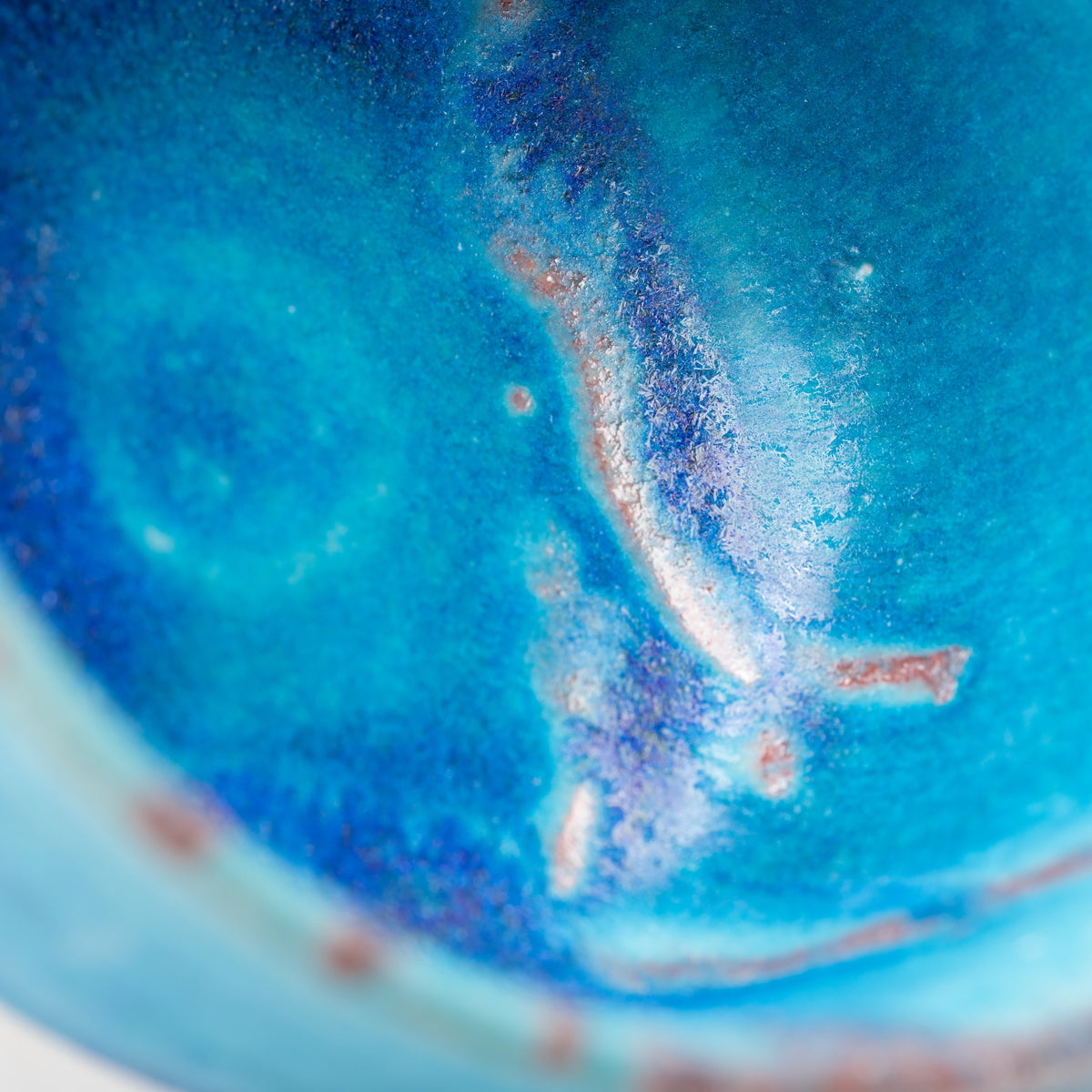 Close-up of the blue glazed interior and pooled surface texture.