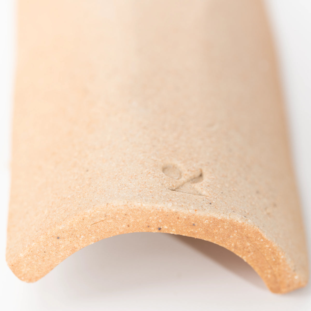 Close-up of the stamped mark underneath the brown incense tray.