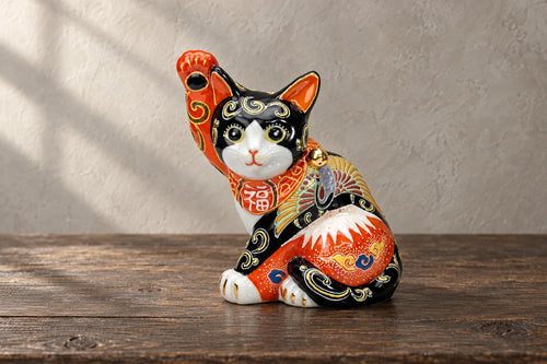 lucky cats โ selected objects on a wooden studio table.