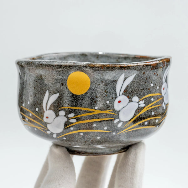 Kōzan Kutani Hane-Usagi matcha chawan — three raised-white rabbits over susuki grass, an example of a modern Japanese tea bowl in the chanoyu tradition.