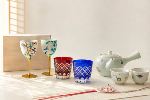 Paired Japanese Kutani cups and Edo Kiriko glasses arranged as wedding gifts on warm washi paper