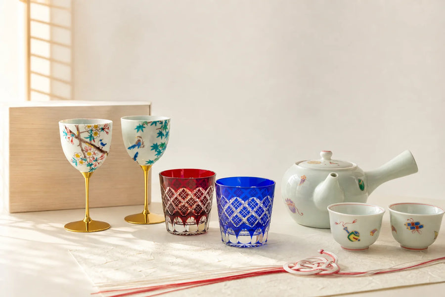 Paired Japanese Kutani cups and Edo Kiriko glasses arranged as wedding gifts on warm washi paper