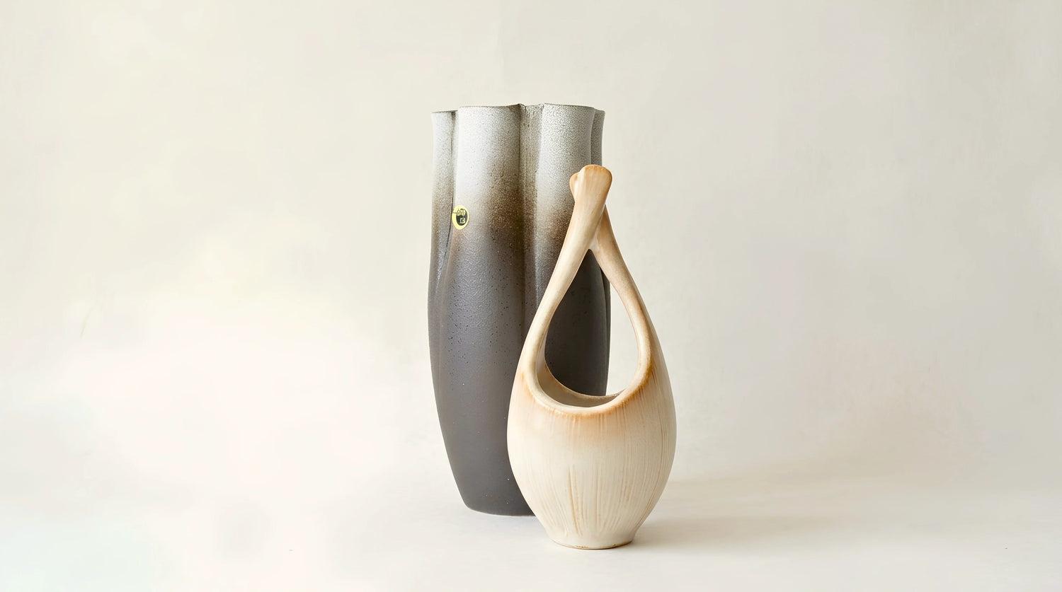 Japanese ikebana vases clustered small at the centre on washi.