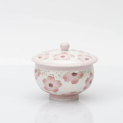 Pink cherry blossom teacup with matching lid, a pearly white finish, and a pale pink rim, foot, and rounded lid knob.