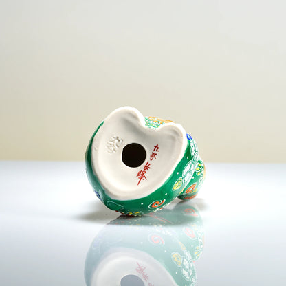Bottom base view of the Kutani porcelain cat showing the red hand-painted artist signature and impressed Kutani foot mark.