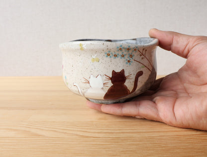 Hand holding Kutani Hidamari matcha bowl to show scale