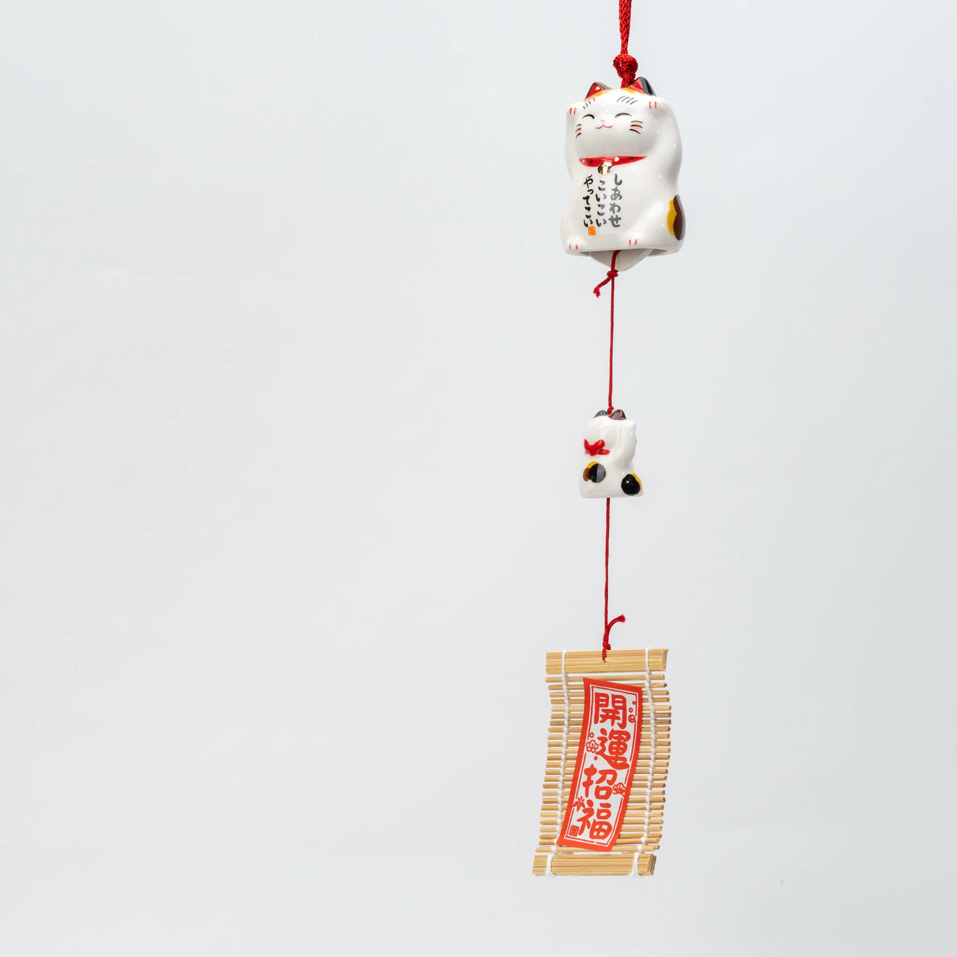 Calico maneki neko ceramic wind chime, parent cat, kitten and slatted wind catcher on one red cord