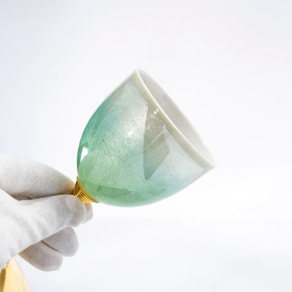 Kutani green wine cup laid on its side