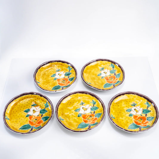 Top view of five Kutani yellow-ground camellia dessert plates arranged together