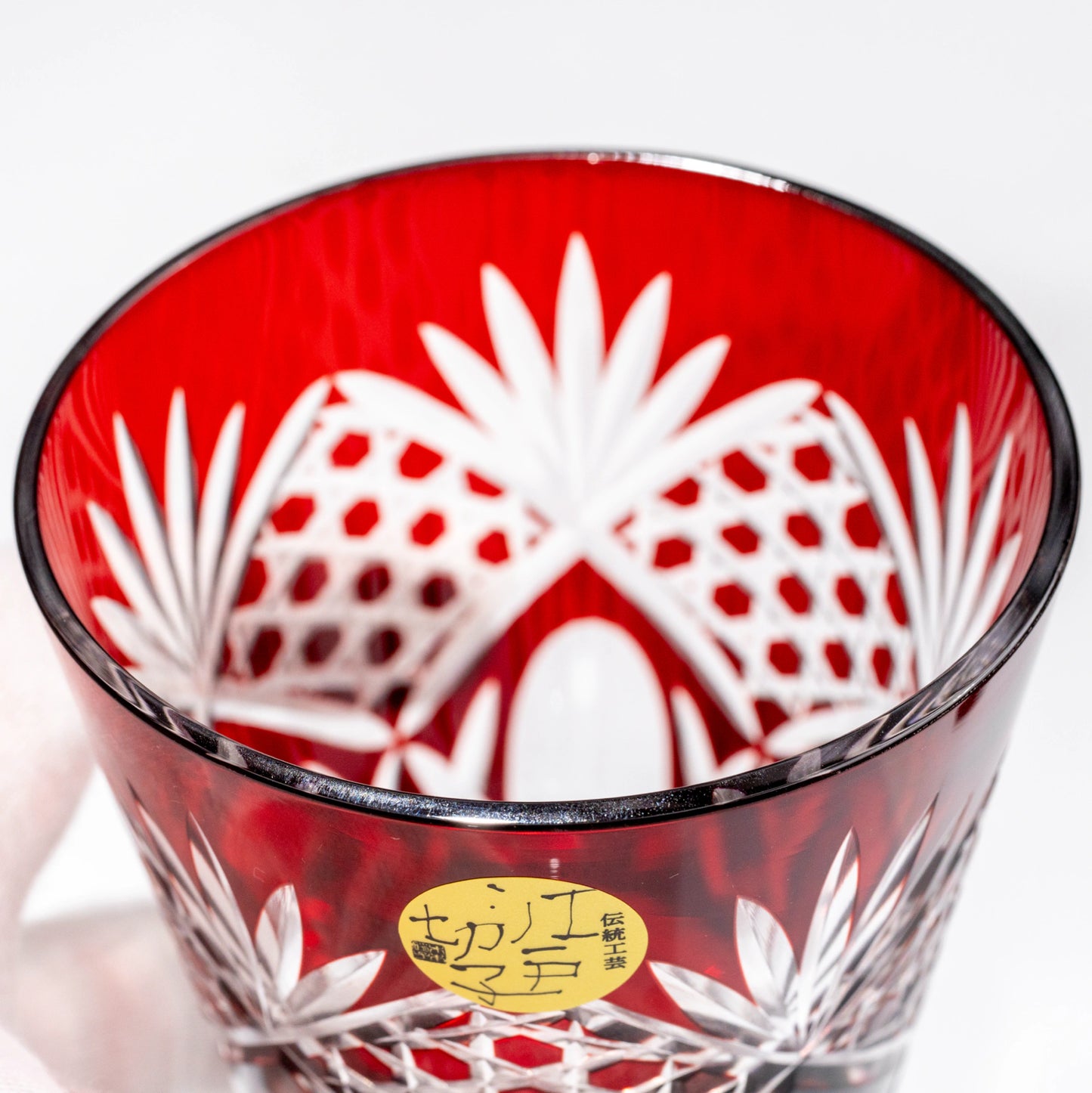 Top view of a red Edo Kiriko whiskey tumbler showing the cut-glass interior