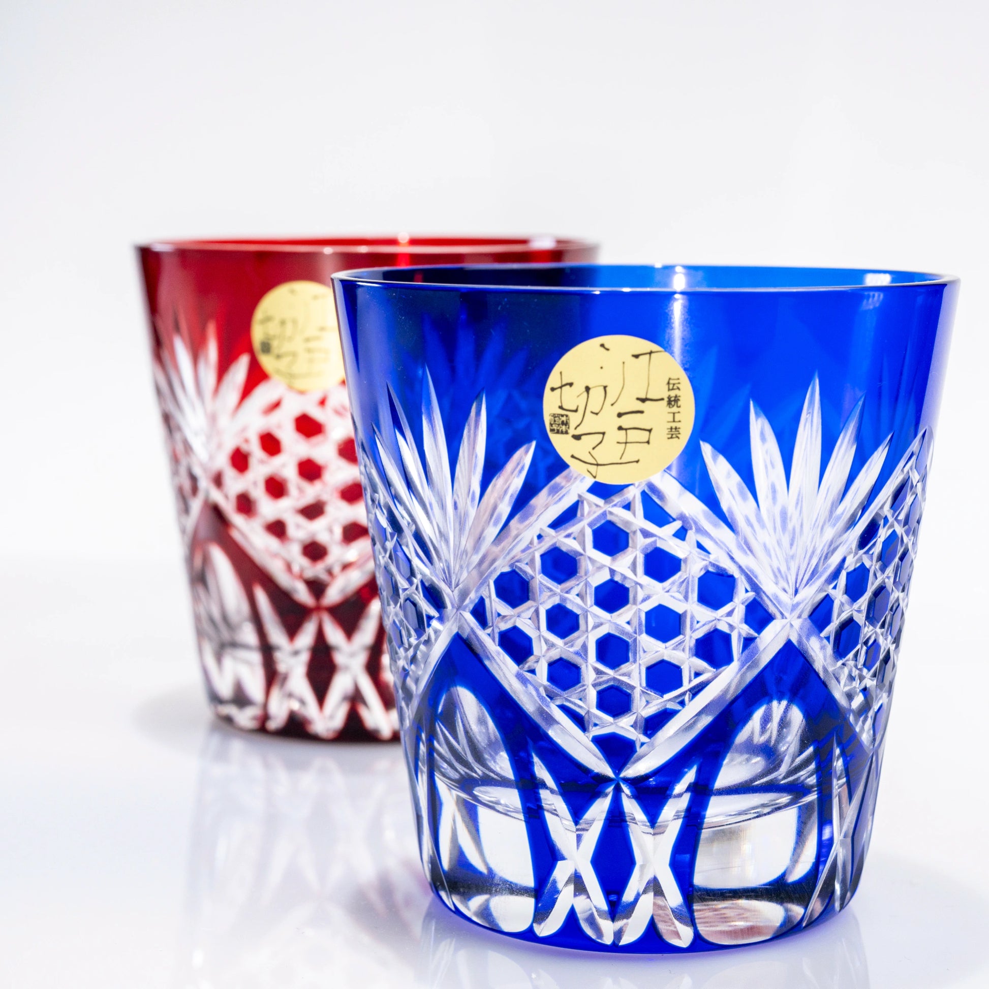 Front view of red and blue Edo Kiriko whiskey tumblers side by side