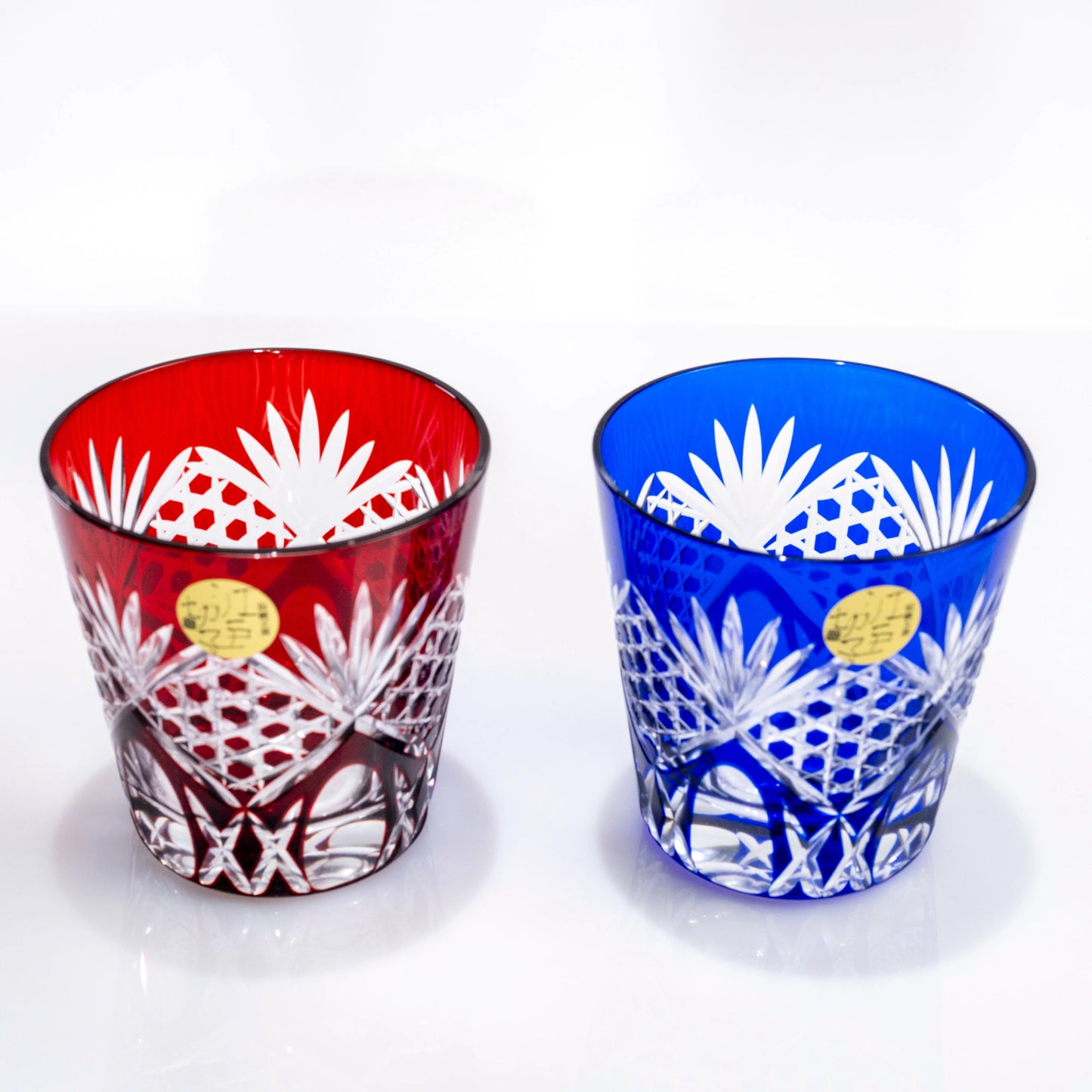 Red and blue Edo Kiriko whiskey tumbler pair with geometric cut-glass pattern
