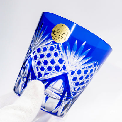 Angled view of a blue Edo Kiriko whiskey tumbler showing cut-glass detail