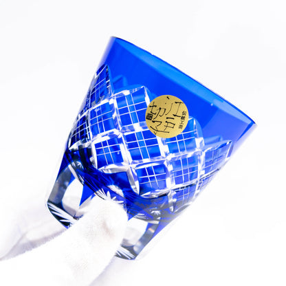 Blue Edo Kiriko old glass held at an angle showing layered cut pattern