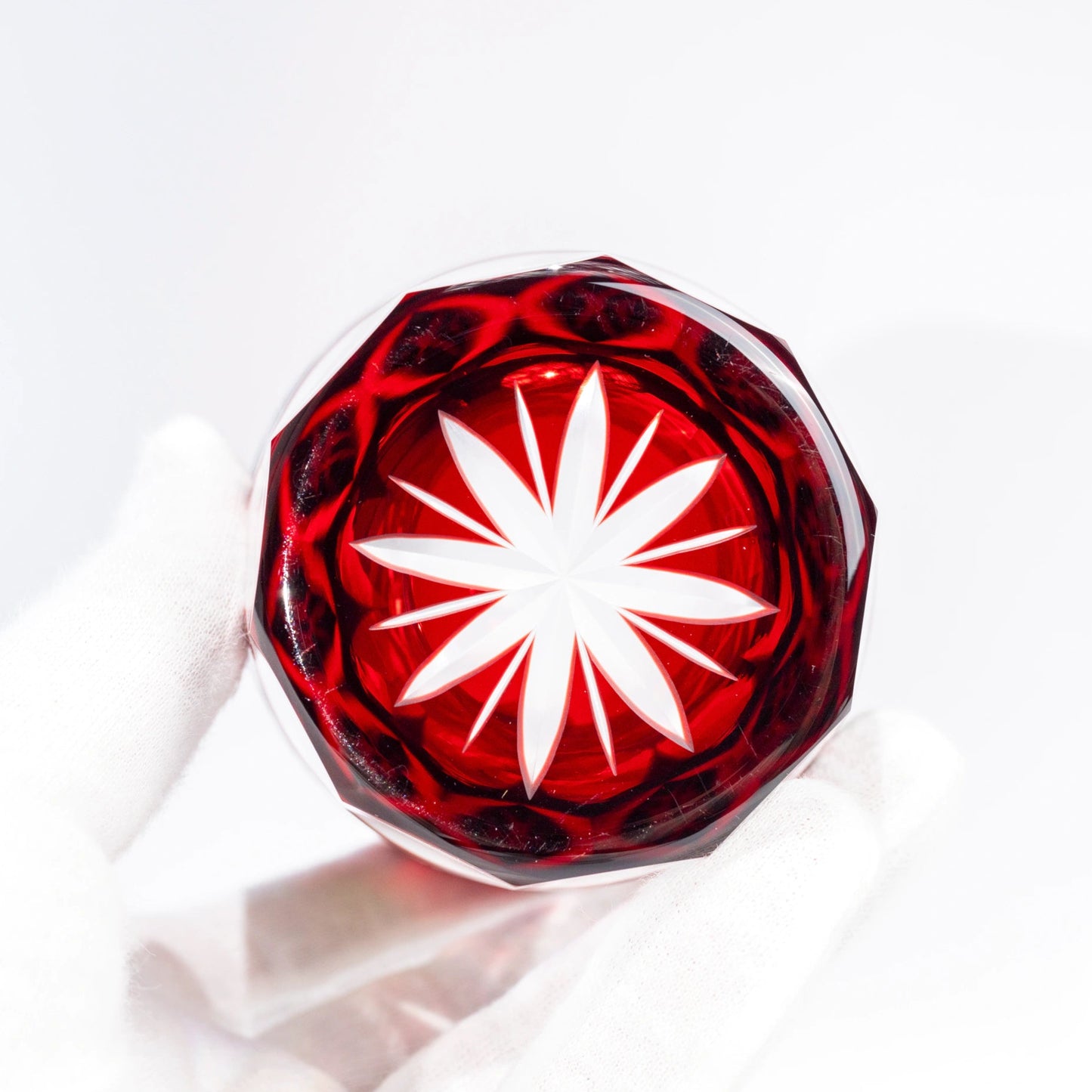 Base view of red Edo Kiriko tumbler showing star cut underside