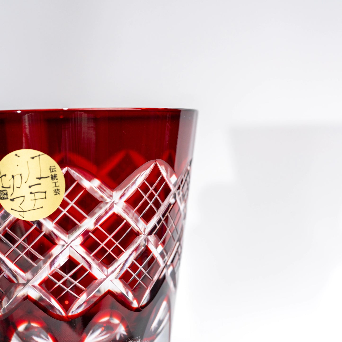 Close-up of red Edo Kiriko whiskey tumbler showing cut glass detail