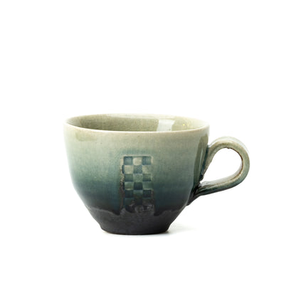 Hechimon Mosaic cup showing a vertical checkered panel and green-to-dark glaze, with the handle to the right.