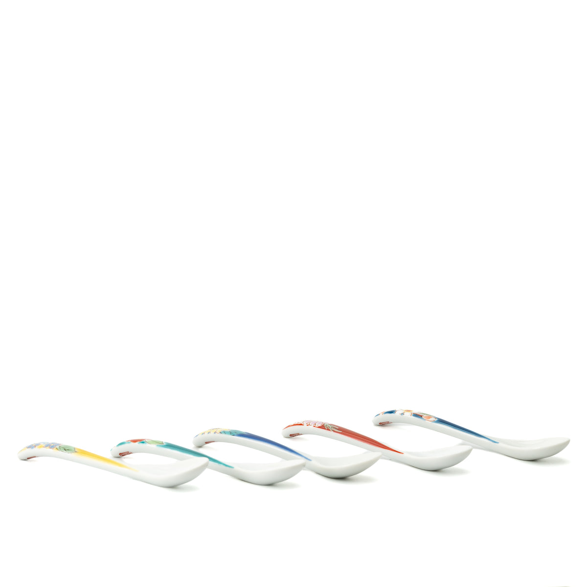 Low side view of five Kutani tea spoons showing the curved handles and shallow bowls.