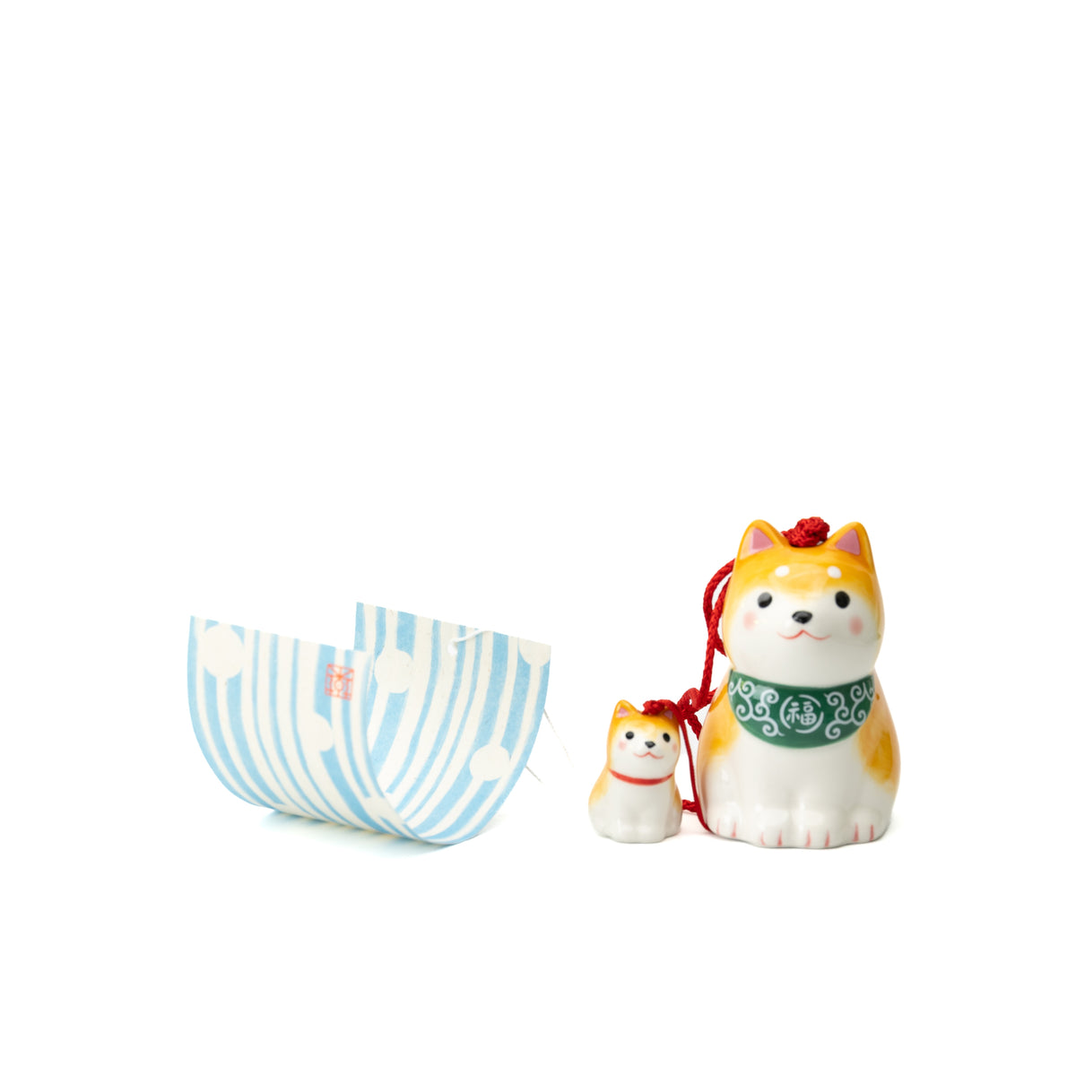 Yellow Shiba parent and puppy wind chime with a green patterned bib and curled striped paper tag.