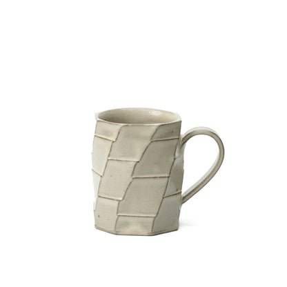 Tall Hechimon Greige mug with a loop handle and an irregular geometric panel pattern.