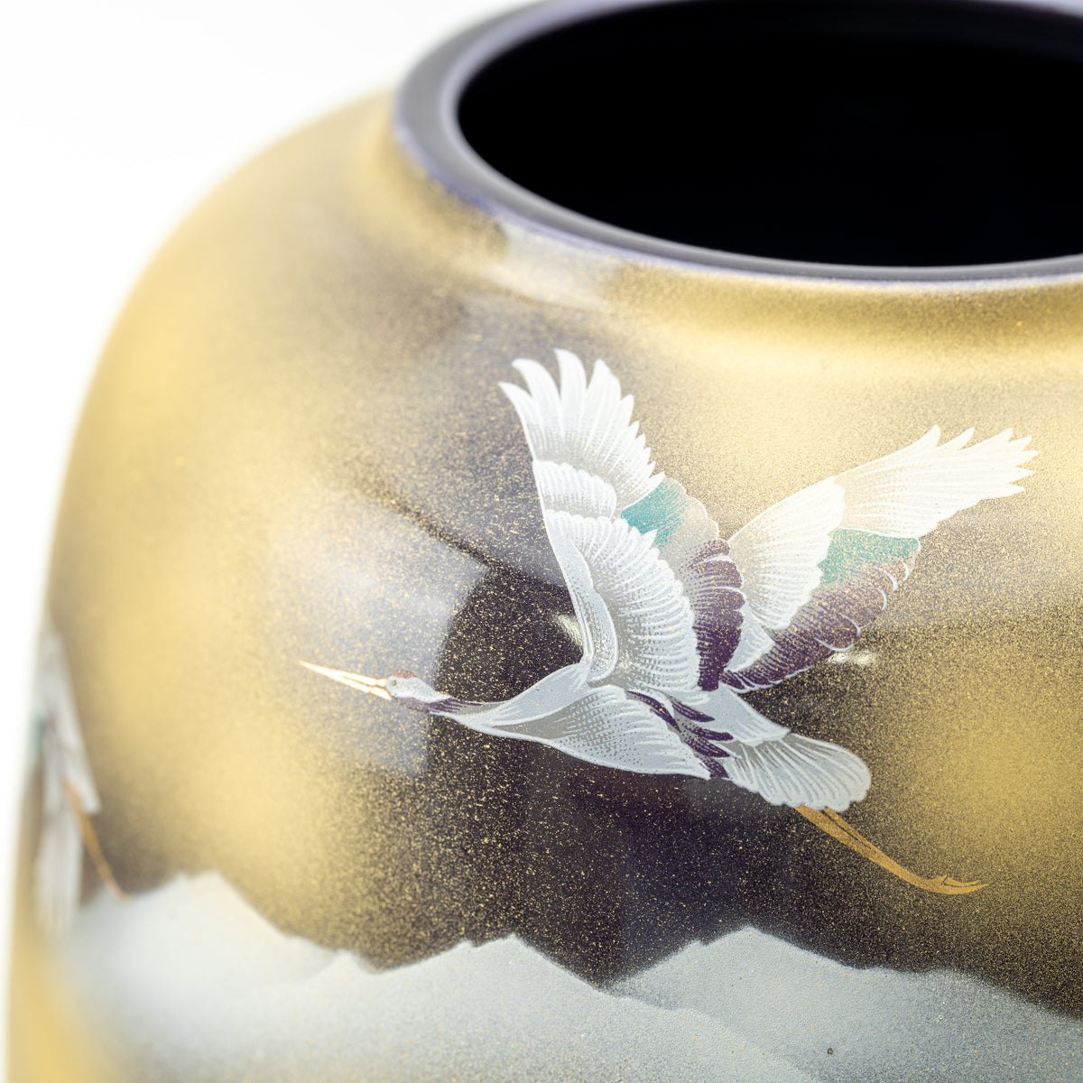Close-up of flying cranes below the Kutani vase's dark opening and gold-toned shoulder.