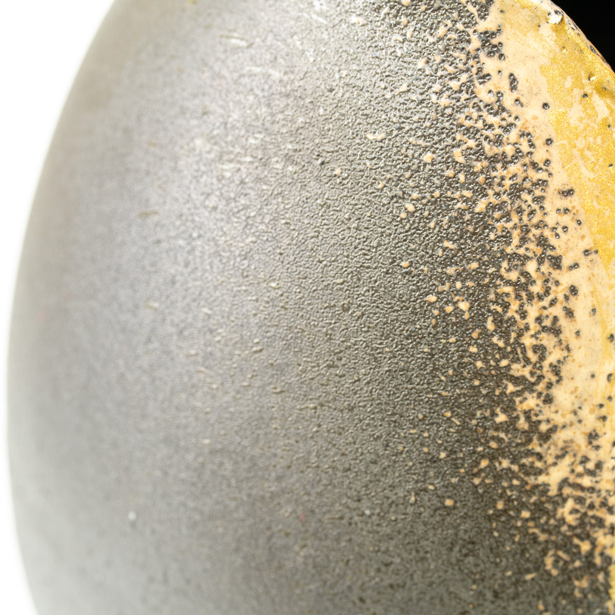 Detail of the Banju vase's finely textured gray surface and speckled gold-colored edge.