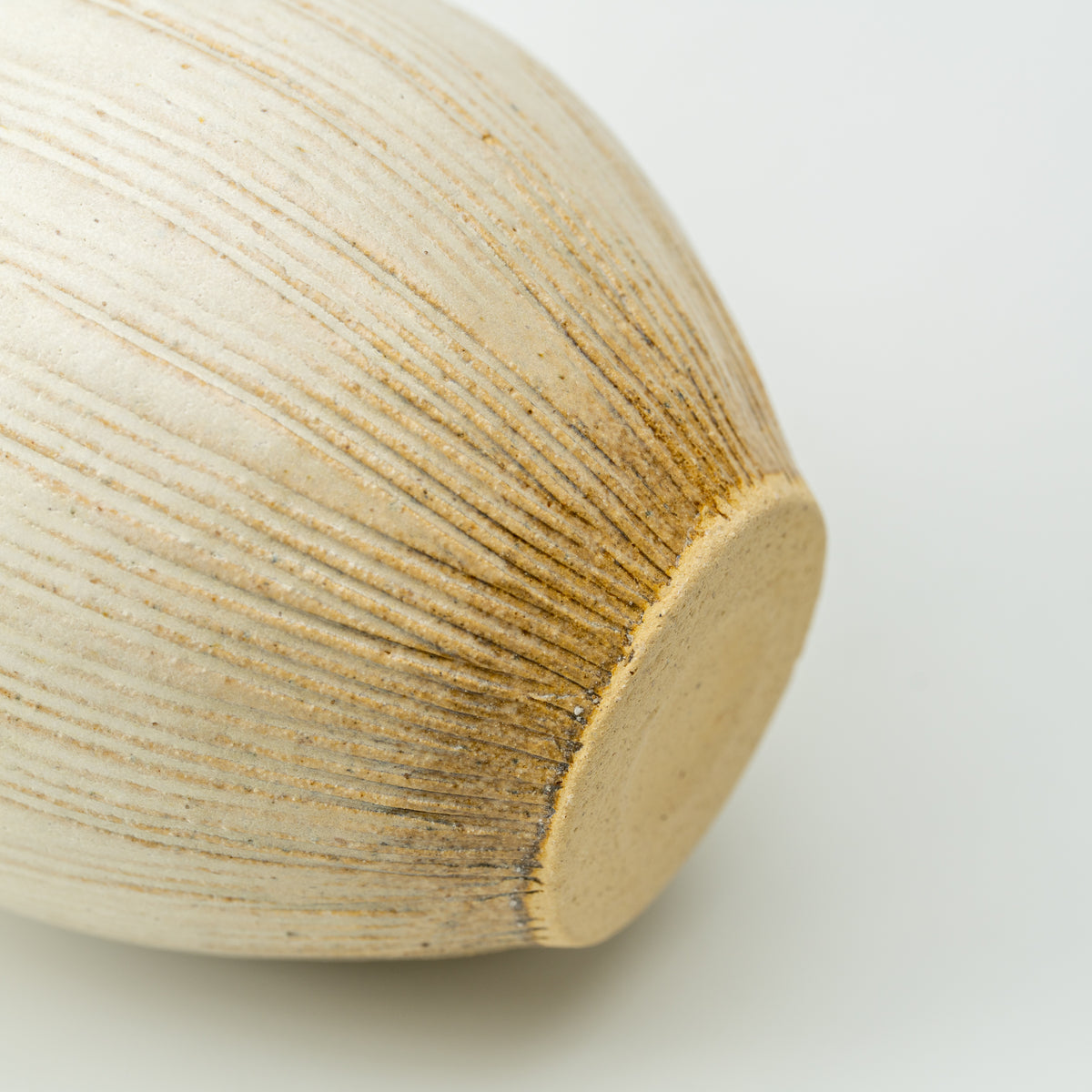 Detail of the Kairo vase's flat unglazed base and fine ridges radiating up the body.