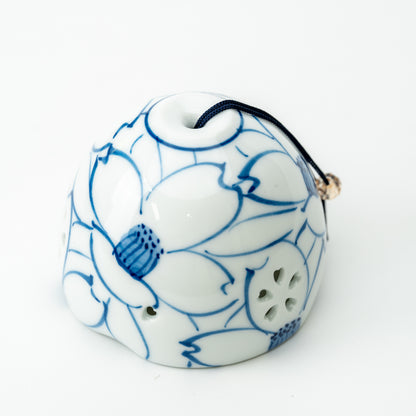 Arita wind-chime bell with blue-outlined camellias, a dark hanging cord and flower-shaped openings.