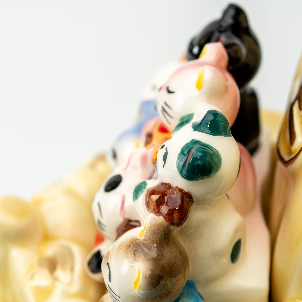 Side close-up of the lucky cats lined up aboard the yellow treasure ship.
