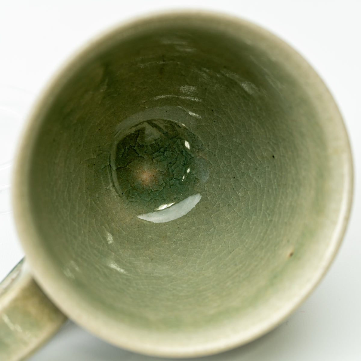 Top view into the Hechimon Mosaic cup showing green glaze and fine crackle lines.