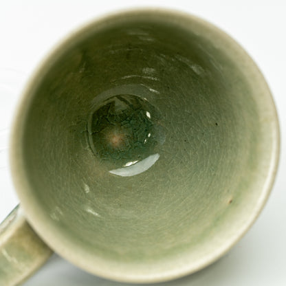 Top view into the Hechimon Mosaic cup showing green glaze and fine crackle lines.