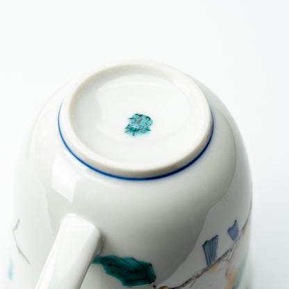 Underside of the Mejiro bird mug showing a small green mark and blue line around the foot.