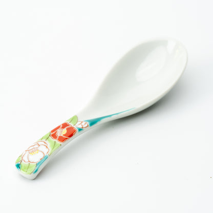 White Kutani soup spoon with red and pale flowers on a turquoise-accented handle.