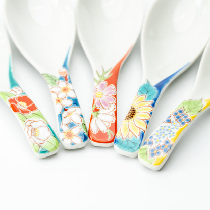 Close-up of five Kutani soup spoon handles with different colorful floral designs.